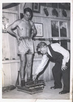 CARPENTIER, GEORGES ORIGINAL WIRE PHOTO (WEIGHING IN AT TRAINING CAMP)