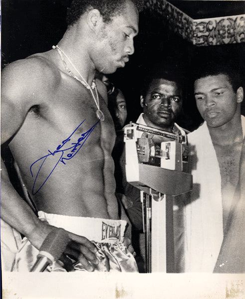 NORTON, KEN SIGNED WIRE PHOTO (WEIGHING IN WITH MUHAMMAD ALI)