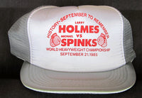 HOLMES, LARRY-MICHAEL SPINKS I SOUVENIR CAP (1985)