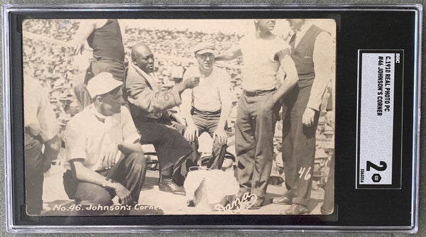 JOHNSON, JACK-JAMES JEFFRIES REAL PHOTO POSTCARD (1910-JOHNSON IN HIS CORNER-SGC)