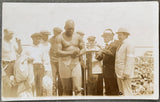 JOHNSON, JACK-JESS WILLARD REAL PHOTO POSTCARD (1915-JOHNSON WEIGHING IN)
